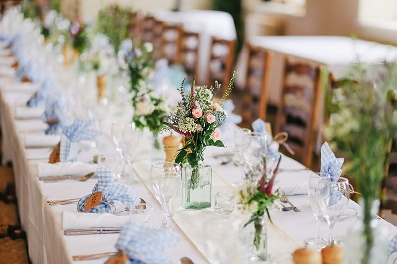 floral setup on a long table for wedding